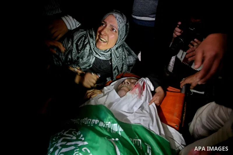 The daughter of Abed Kareem Zaytoneya mourns next to his body during his funeral in Gaza City February 12, 2012. An Israeli air strike on the Gaza Strip killed a Palestinian civilian, Zaytoneya, on Sunday, hospital offic...