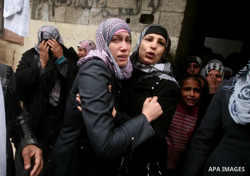 Relatives of Abed Kareem Zaytoneya mourns next to his body during his funeral in Gaza City February 12, 2012. An Israeli air strike on the Gaza Strip killed a Palestinian civilian, Zaytoneya, on Sunday, hospital official...