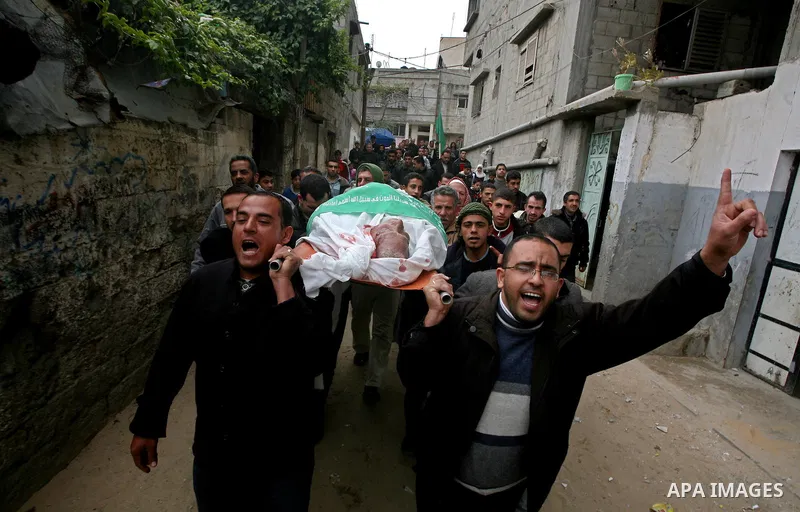 Palestinians carry the body of Abed Kareem Zaytoneya during his funeral in Gaza City February 12, 2012. An Israeli air strike on the Gaza Strip killed a Palestinian civilian, Zaytoneya, on Sunday, hospital officials said...