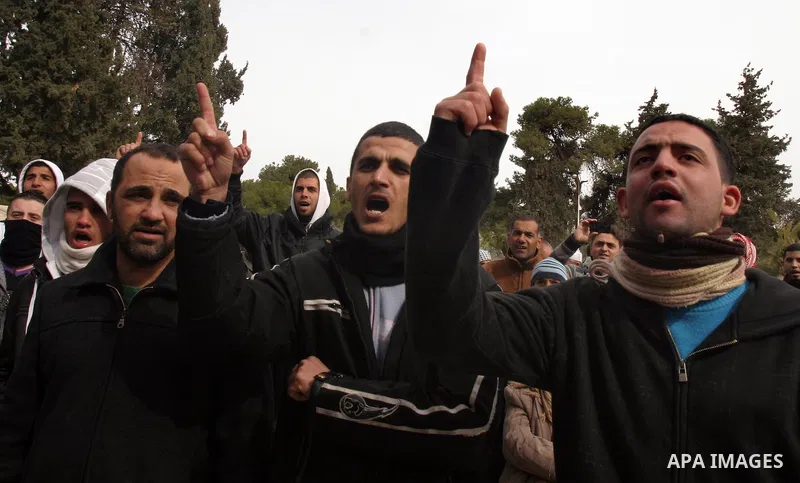 Palestinians protestors gather in front of Al-Aqsa mosque in the old city of Jerusalem, on February 12, 2012, as Israeli Police barred non-Muslims from visiting the Al-Aqsa mosque complex after right-wing Jewish activist...