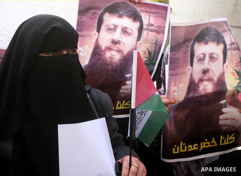Palestinian women hold posters depicting Palestinian prisoner Khader Adnan, a member of the Islamic Jihad militant group, during a protest in Gaza City, calling for the release of Palestinian prisoners from Israeli jails...