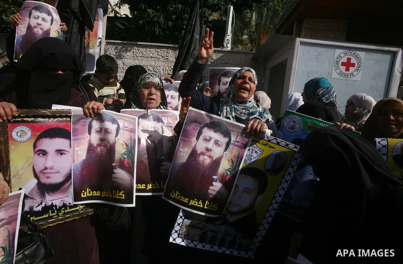 Palestinian women hold posters depicting Palestinian prisoner Khader Adnan, a member of the Islamic Jihad militant group, during a protest in Gaza City, calling for the release of Palestinian prisoners from Israeli jails...