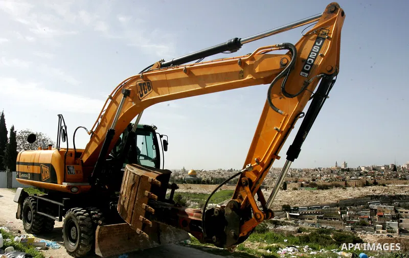Israeli soldiers keep watch as a bulldozer demolishes on February 13, 2012 a Palestinian cbelonging to Jerusalem resident Ahmad al-Baghdadi that was built without the municipality's permission in the holy city's Arab nei...