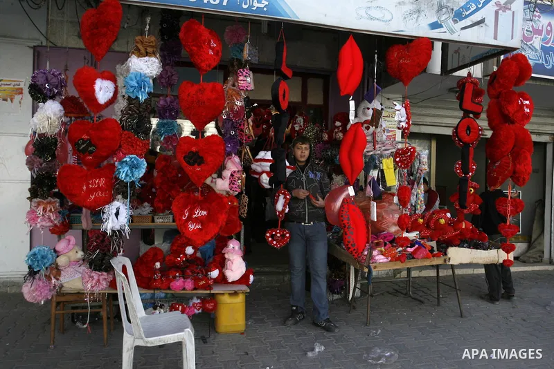 Palestinian man displays hearts in the shop to commemorate Valentine's Day adorned with sayings about love, in Rafah, southern Gaza Strip on February 13, 2012. Valentine's Day is celebrated each year on 14 February. Phot...