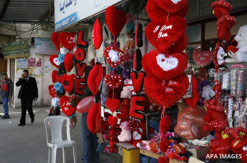 Palestinian man displays hearts in the shop to commemorate Valentine's Day adorned with sayings about love, in Rafah, southern Gaza Strip on February 13, 2012. Valentine's Day is celebrated each year on 14 February. Phot...
