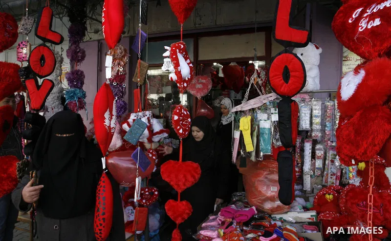 Palestinian man displays hearts in the shop to commemorate Valentine's Day adorned with sayings about love, in Rafah, southern Gaza Strip on February 13, 2012. Valentine's Day is celebrated each year on 14 February. Phot...
