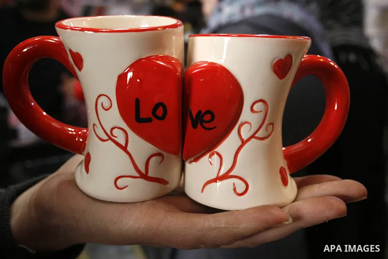 Palestinian man displays hearts in the shop to commemorate Valentine's Day adorned with sayings about love, in Rafah, southern Gaza Strip on February 13, 2012. Valentine's Day is celebrated each year on 14 February. Phot...