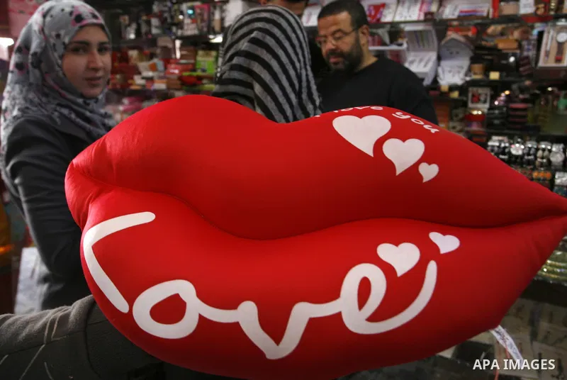 Palestinian man displays hearts in the shop to commemorate Valentine's Day adorned with sayings about love, in Rafah, southern Gaza Strip on February 13, 2012. Valentine's Day is celebrated each year on 14 February. Phot...
