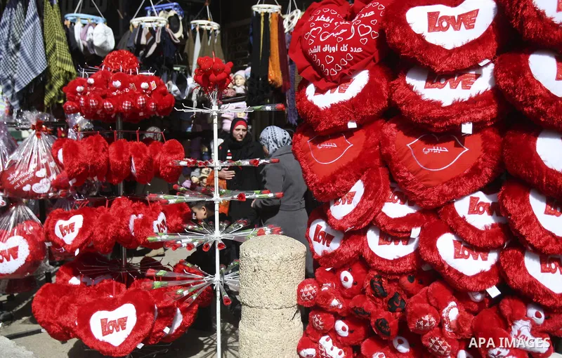 Palestinian man displays hearts in the shop to commemorate Valentine's Day adorned with sayings about love, in West Bank City of Nablus, on February 13, 2012. Valentine's Day is celebrated each year on 14 February. Photo...
