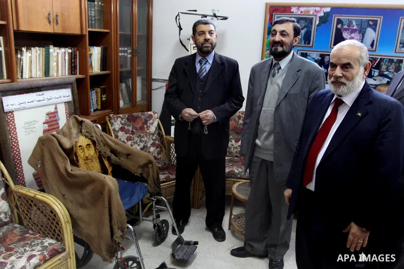A Palestinian member of Hamas movement political bureau, Emad Al-Alami is welcomed by Hamas movement leaders and others after his arrival to Gaza Strip, in Gaza city on Feb. 13, 2012. Photo by Mohammed Asad