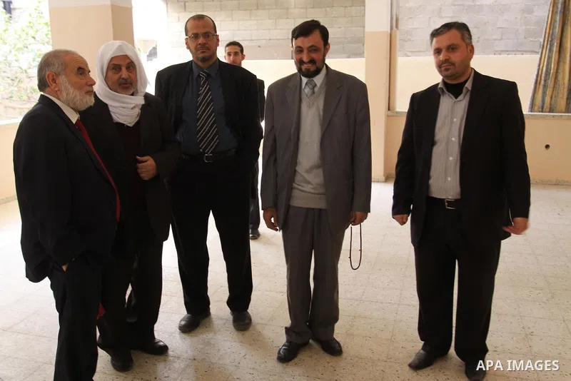 A Palestinian member of Hamas movement political bureau, Emad Al-Alami is welcomed by Hamas movement leaders and others after his arrival to Gaza Strip, in Gaza city on Feb. 13, 2012. Photo by Mohammed Asad