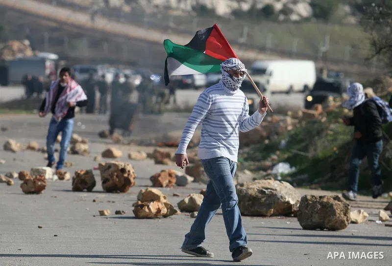 Palestinian protesters hurls stones at Israel security forces during clashes outside the Ofer military prison near the West Bank city of Ramallah, Monday, Feb. 13, 2012. Clashes between dozens of Palestinians and Israeli...