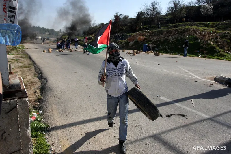 Palestinian protesters hurls stones at Israel security forces during clashes outside the Ofer military prison near the West Bank city of Ramallah, Monday, Feb. 13, 2012. Clashes between dozens of Palestinians and Israeli...