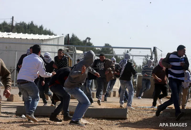Palestinian protesters hurls stones at Israel security forces during clashes outside the Ofer military prison near the West Bank city of Ramallah, Monday, Feb. 13, 2012. Clashes between dozens of Palestinians and Israeli...