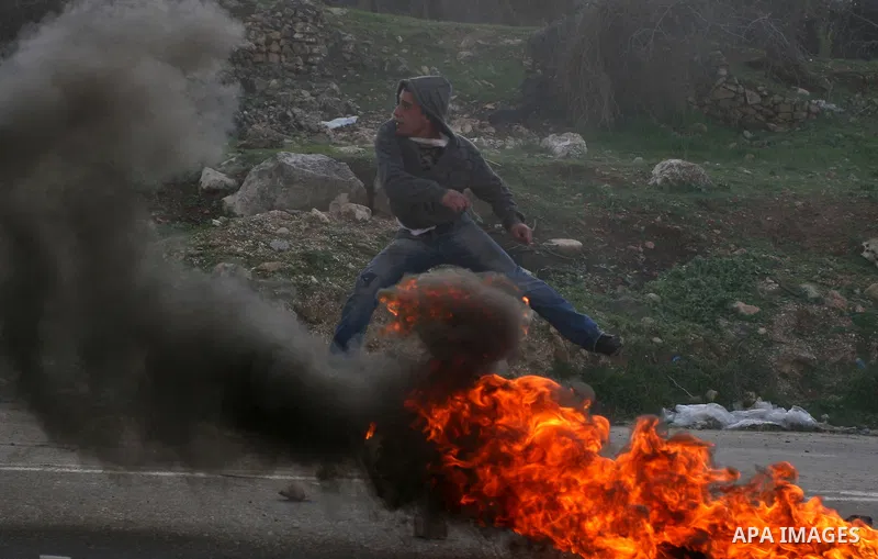 Palestinian protesters hurls stones at Israel security forces during clashes outside the Ofer military prison near the West Bank city of Ramallah, Monday, Feb. 13, 2012. Clashes between dozens of Palestinians and Israeli...