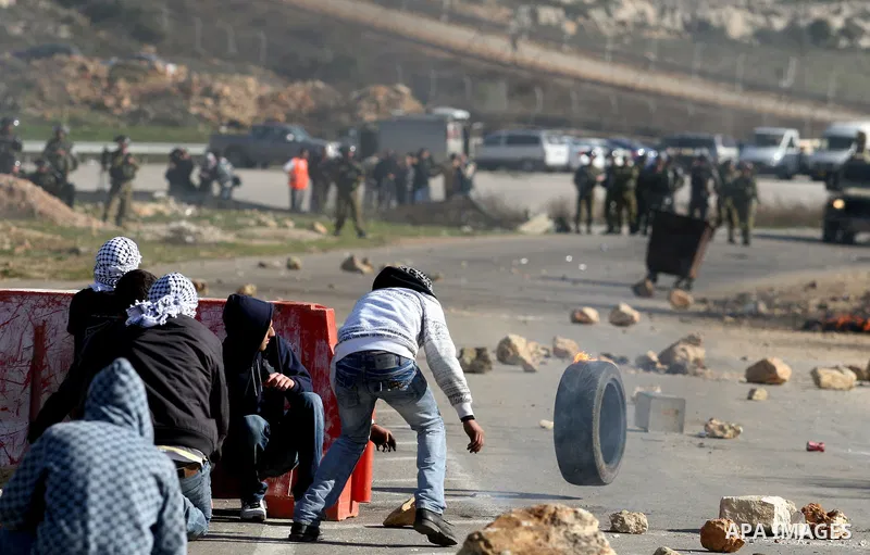 Palestinian protesters hurls stones at Israel security forces during clashes outside the Ofer military prison near the West Bank city of Ramallah, Monday, Feb. 13, 2012. Clashes between dozens of Palestinians and Israeli...