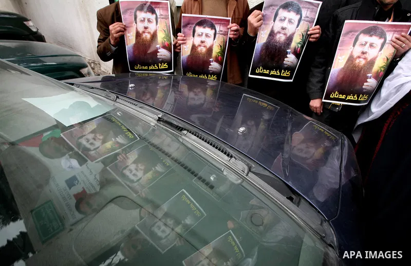 Palestinians hold posters depicting Palestinian prisoner Khader Adnan, a member of the Islamic Jihad militant group, during a protest in front of French Center calling for his release in Gaza City, February 14, 2012. Adn...