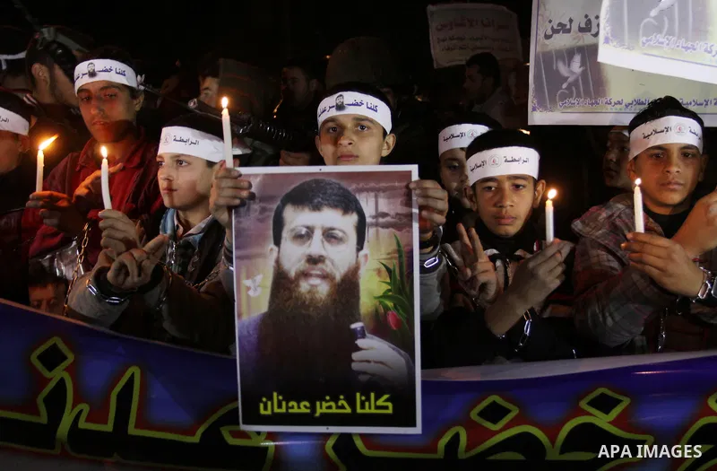 Palestinians participate in a protest in solidarity with Khader Adnan, 33, a senior member of Islamic Jihad jailed in Israel who has been on hunger strike for 59 days as they called for the release of Palestinian prisone...