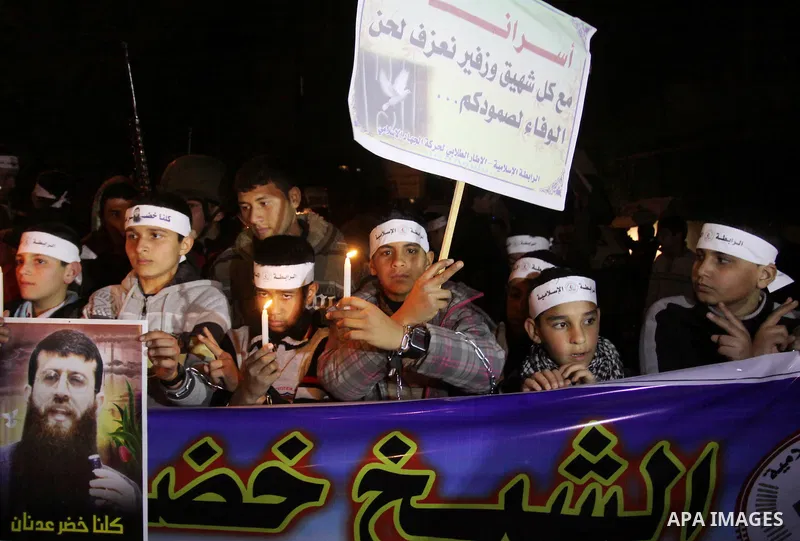 Palestinians participate in a protest in solidarity with Khader Adnan, 33, a senior member of Islamic Jihad jailed in Israel who has been on hunger strike for 59 days as they called for the release of Palestinian prisone...