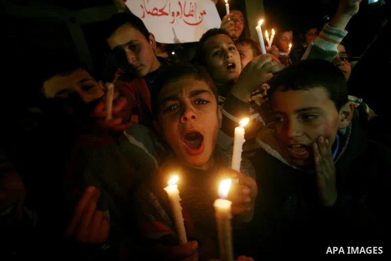 Palestinian schoolchildren hold up candles during a portest in Gaza City calling for supplying the Gaza Strip with enough fuel on February 14, 2012. The impoverished territory's sole power plant, which supplies around a...