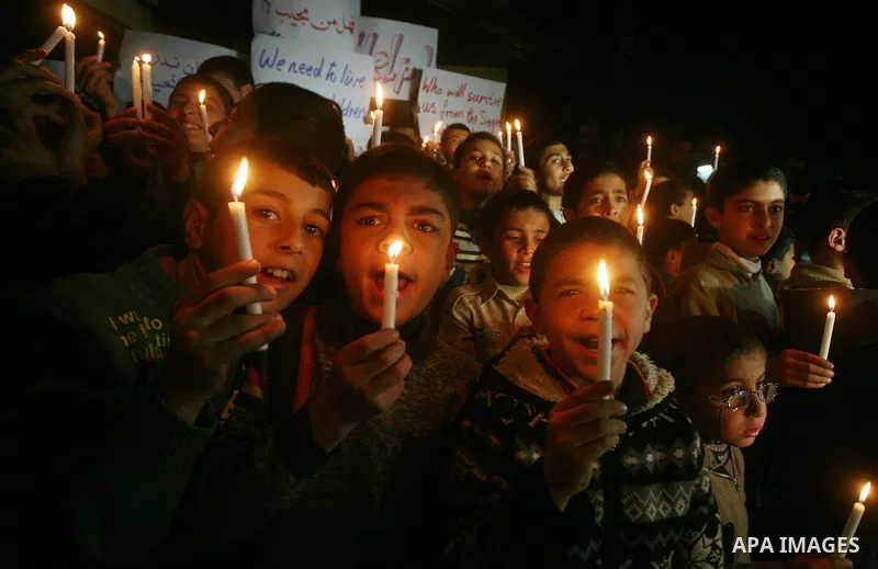 Palestinian schoolchildren hold up candles during a portest in Gaza City calling for supplying the Gaza Strip with enough fuel on February 14, 2012. The impoverished territory's sole power plant, which supplies around a...