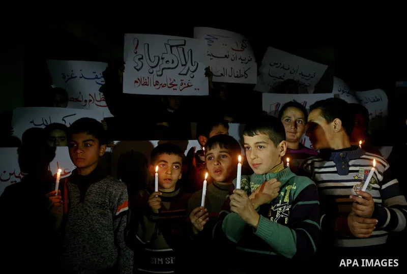 Palestinian schoolchildren hold up candles during a portest in Gaza City calling for supplying the Gaza Strip with enough fuel on February 14, 2012. The impoverished territory's sole power plant, which supplies around a...