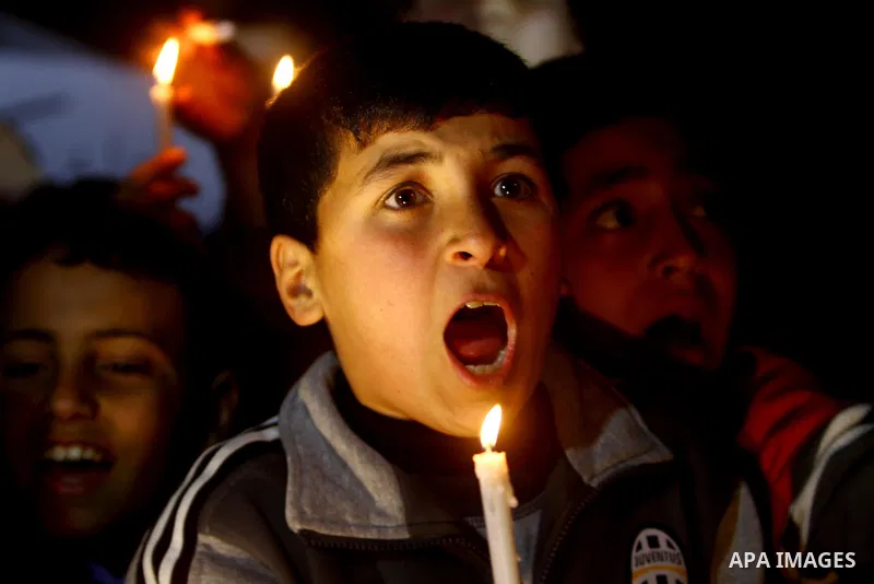 Palestinian schoolchildren hold up candles during a portest in Gaza City calling for supplying the Gaza Strip with enough fuel on February 14, 2012. The impoverished territory's sole power plant, which supplies around a...