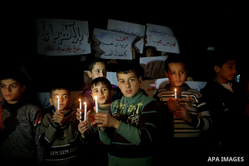 Palestinian schoolchildren hold up candles during a portest in Gaza City calling for supplying the Gaza Strip with enough fuel on February 14, 2012. The impoverished territory's sole power plant, which supplies around a...