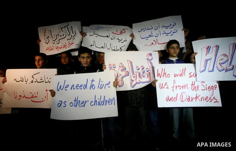 Palestinian schoolchildren hold up candles during a portest in Gaza City calling for supplying the Gaza Strip with enough fuel on February 14, 2012. The impoverished territory's sole power plant, which supplies around a...