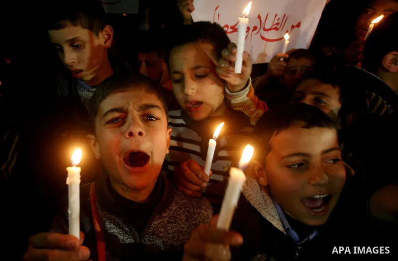 Palestinian schoolchildren hold up candles during a portest in Gaza City calling for supplying the Gaza Strip with enough fuel on February 14, 2012. The impoverished territory's sole power plant, which supplies around a...
