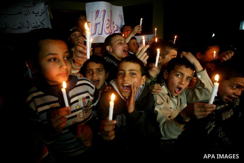 Palestinian schoolchildren hold up candles during a portest in Gaza City calling for supplying the Gaza Strip with enough fuel on February 14, 2012. The impoverished territory's sole power plant, which supplies around a...
