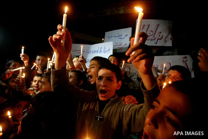 Palestinian schoolchildren hold up candles during a portest in Gaza City calling for supplying the Gaza Strip with enough fuel on February 14, 2012. The impoverished territory's sole power plant, which supplies around a...
