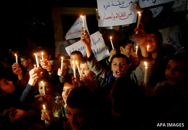 Palestinian schoolchildren hold up candles during a portest in Gaza City calling for supplying the Gaza Strip with enough fuel on February 14, 2012. The impoverished territory's sole power plant, which supplies around a...
