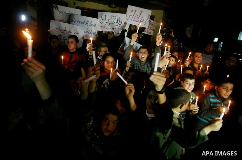 Palestinian schoolchildren hold up candles during a portest in Gaza City calling for supplying the Gaza Strip with enough fuel on February 14, 2012. The impoverished territory's sole power plant, which supplies around a...