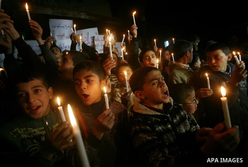 Palestinian schoolchildren hold up candles during a portest in Gaza City calling for supplying the Gaza Strip with enough fuel on February 14, 2012. The impoverished territory's sole power plant, which supplies around a...