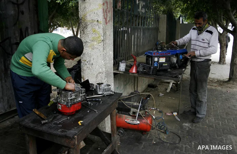 A Palestinian man fixes a generator at a shop in Rafah in the southern Gaza Strip, on February 14, 2012. The people of the Gaza Strip use a large number of generators because of the continuing lack of electricity in the...