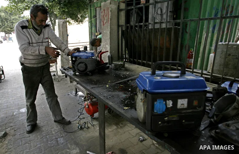 A Palestinian man fixes a generator at a shop in Rafah in the southern Gaza Strip, on February 14, 2012. The people of the Gaza Strip use a large number of generators because of the continuing lack of electricity in the...