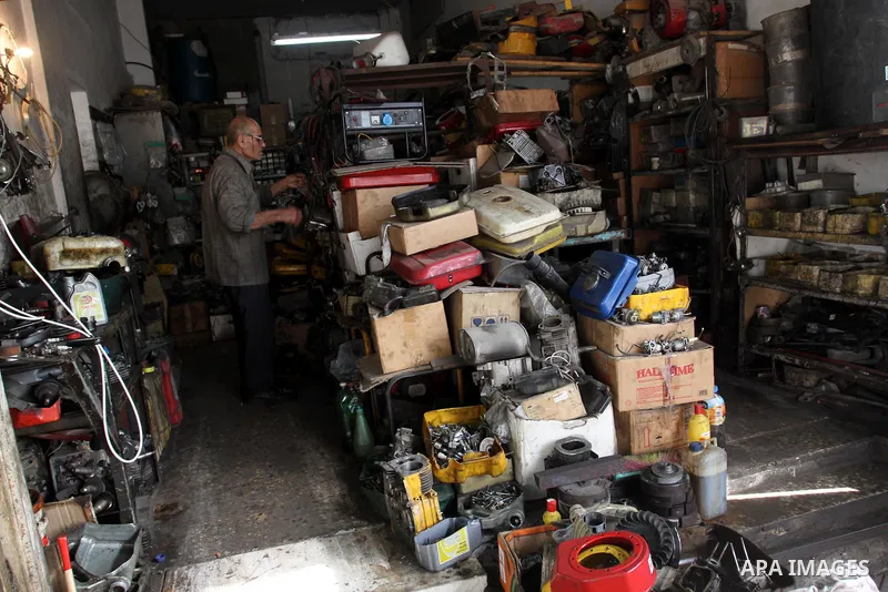 A Palestinian man fixes a generator at a shop in Gaza City, on February 15, 2012. The people of the Gaza Strip use a large number of generators because of the continuing lack of electricity in the Gaza Strip. Photo by Mo...