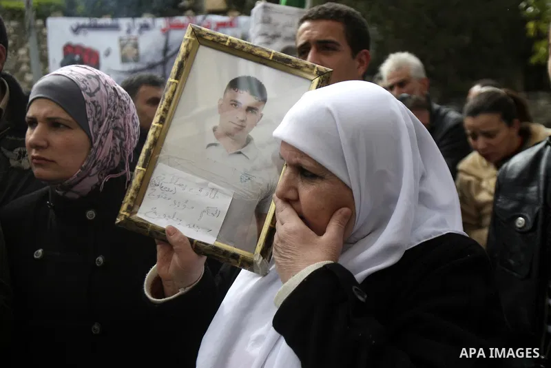 Palestinians hold up a pictures to Khader Adnan, 33, a jailed senior member of Islamic Jihad who has been on hunger strike for nearly 60 days days as they called for the release of Palestinian prisoners jailed in Israel,...