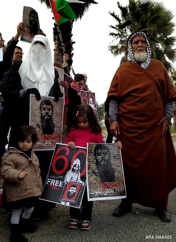 Randa, the wife of Palestinian prisoner Khader Adnan (poster), a jailed senior member of Islamic Jihad who has been on hunger strike for nearly 60 days, during a protest outside Zief hospital in Safad, on February 15, 20...