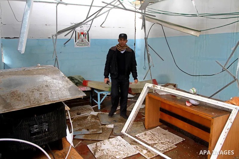 A Hamas police officer looks at the damage to a structure after an Israeli air strike in Gaza City February 16, 2012. The Israeli military said aircraft targeted two militant facilities early on Thursday in response to r...