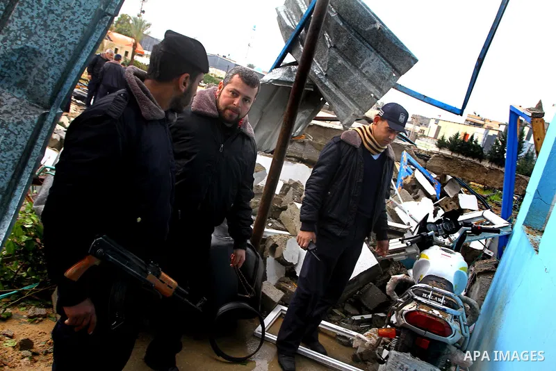 A Hamas police officer looks at the damage to a structure after an Israeli air strike in Gaza City February 16, 2012. The Israeli military said aircraft targeted two militant facilities early on Thursday in response to r...