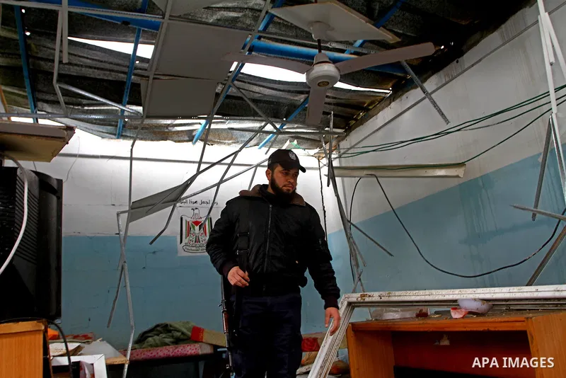 A Hamas police officer looks at the damage to a structure after an Israeli air strike in Gaza City February 16, 2012. The Israeli military said aircraft targeted two militant facilities early on Thursday in response to r...