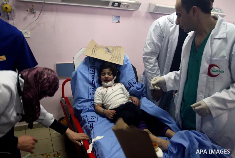 Palestinian paramedics transfer a wounded on wheel to the hospital, at the an accident near the Qalandiya checkpoint outside the West Bank city of Ramallah February 16, 2012. At least five Palestinian children were kille...