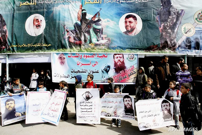 Palestinian students participate in a protest in solidarity with Khader Adnan, 33, a jailed senior member of Islamic Jihad who has been on hunger strike for nearly 60 days days as they called for the release of Palestini...