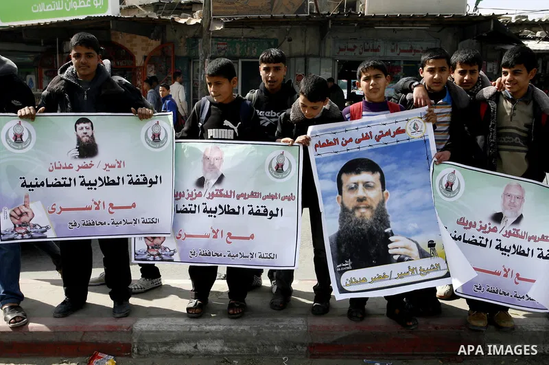 Palestinian students participate in a protest in solidarity with Khader Adnan, 33, a jailed senior member of Islamic Jihad who has been on hunger strike for nearly 60 days days as they called for the release of Palestini...