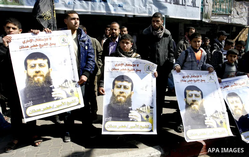Palestinian students participate in a protest in solidarity with Khader Adnan, 33, a jailed senior member of Islamic Jihad who has been on hunger strike for nearly 60 days days as they called for the release of Palestini...