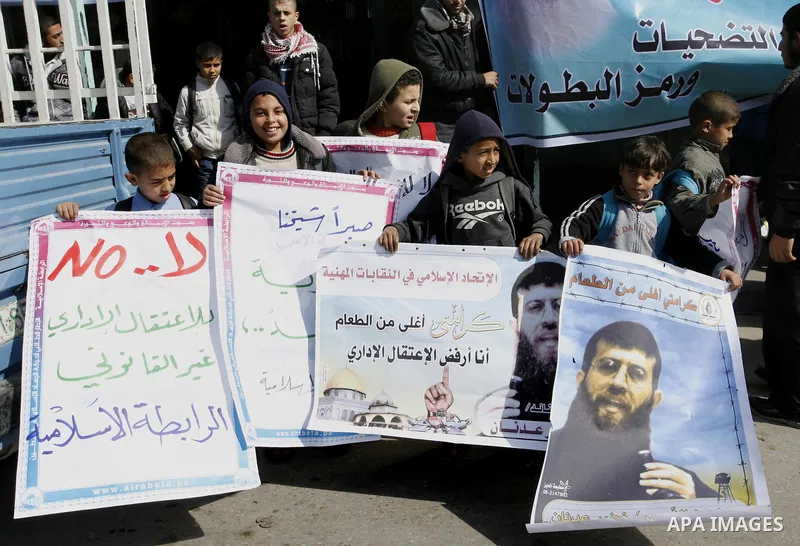 Palestinian students participate in a protest in solidarity with Khader Adnan, 33, a jailed senior member of Islamic Jihad who has been on hunger strike for nearly 60 days days as they called for the release of Palestini...