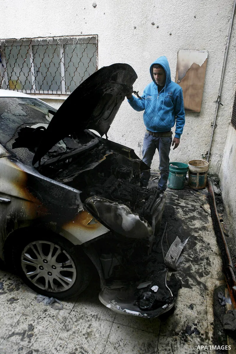 Palestinian shows his burnt car in the West Bank village of Nabi Elyas, near the West Bank city of Qalqilya , 16 Februray 2012. Right wing Israelis are suspected of having burned it. Police arrested an Israeli settler on...