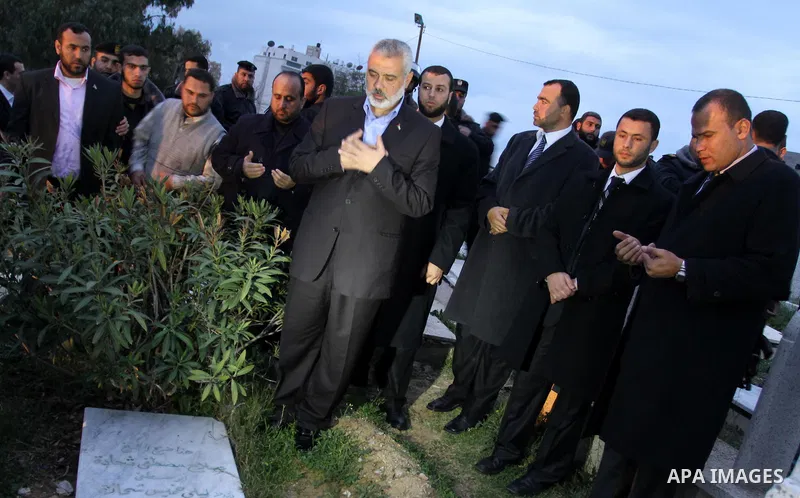 Palestinian prime minister in Gaza Strip, Ismail Haniyah read Holy Quran on the grave of Hamas Salah Shehada, in Gaza city on Feb. 16,2012 after his arrival to Gaza Strip from a tour to Qatar, Bahrain, Kuwait, Iran and U...